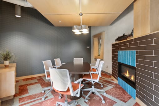 a room with a table and chairs and a fireplace