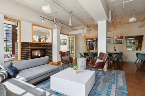a living room with couches chairs and a fireplace
