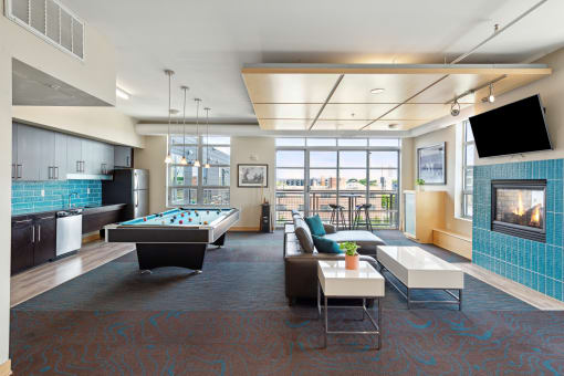 a lounge area with a pool table and television