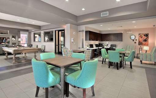 A modern dining room with a table set for six.