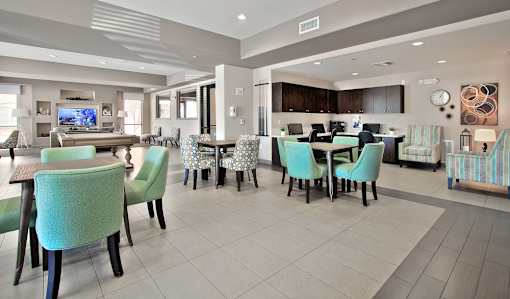 A modern dining room with a glass table and chairs.