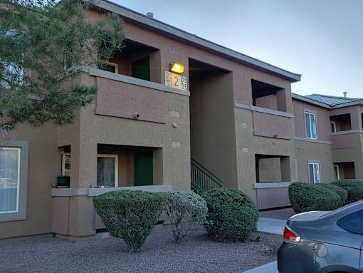 A building with a green door and a number 21 on the wall.