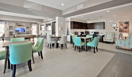 a dining area with tables and chairs and a television