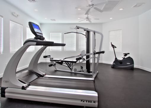 a home gym with a treadmill and exercise equipment