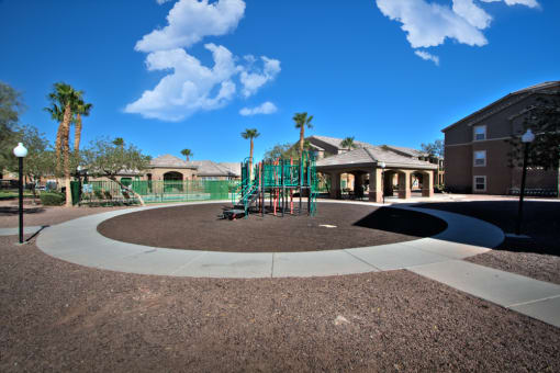 a playground in a park with a building in the background