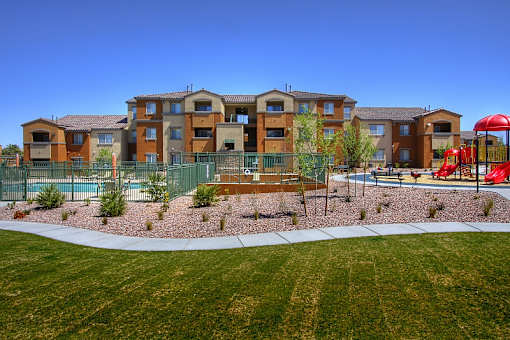 Apartment complex with a playground in front.