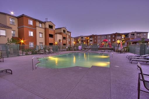 A swimming pool in a courtyard surrounded by apartment buildings.