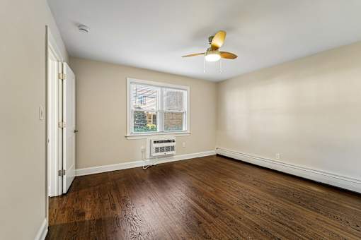 A room with a ceiling fan and a window.