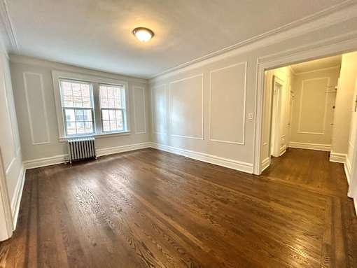 A room with wooden floors and white walls.