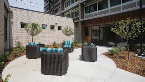 A patio with a table and chairs at Denver Metro Village Apartments, Denver