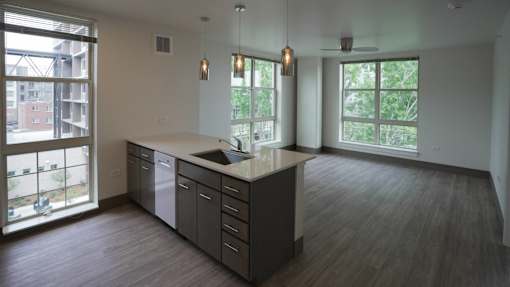 A kitchen with a large island and a view of the outside at Denver Metro Village Apartments, Colorado, 80204