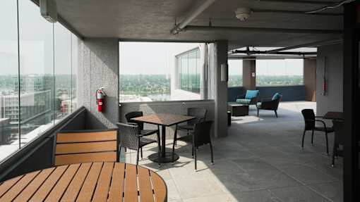 A modern outdoor seating area with a view of the city at Denver Metro Village Apartments, Denver