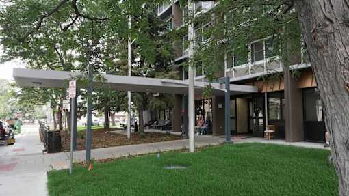 A tree is in front of a building at Denver Metro Village Apartments, Colorado