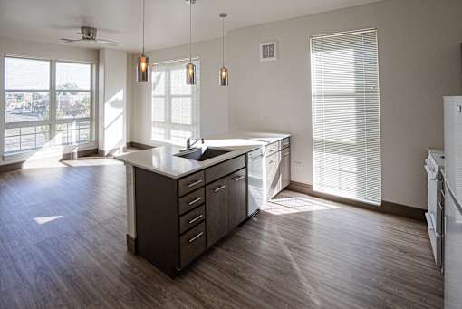 A kitchen with a large island and a fan at Denver Metro Village Apartments, Denver