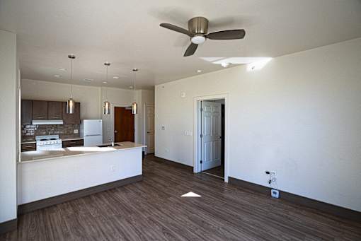 A room with a ceiling fan and a wooden floor at Denver Metro Village Apartments, Denver, Colorado