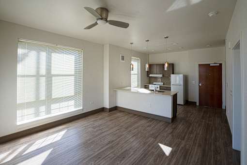 A kitchen with a fan and wooden floors at Denver Metro Village Apartments, Colorado