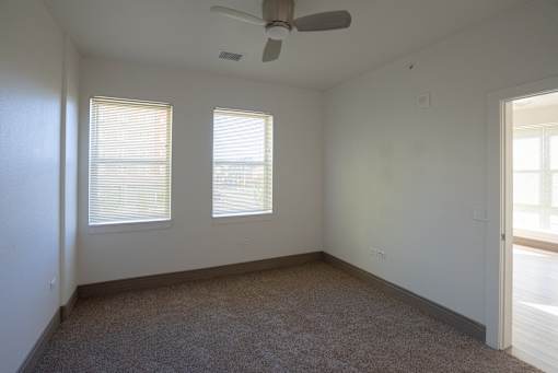 A room with a ceiling fan and carpeted floor at Denver Metro Village Apartments, Denver, 80204