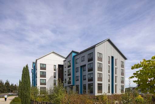 A modern building with a mix of white and blue exterior.