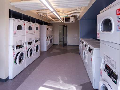 A row of washing machines in a laundromat.
