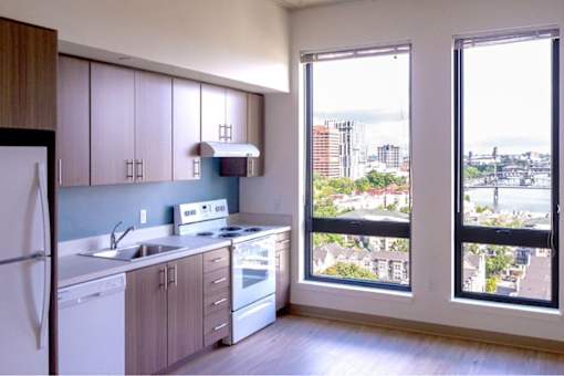 A kitchen with white appliances and wooden cabinets.