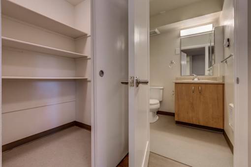 A white bathroom with a toilet, sink, and medicine cabinet.