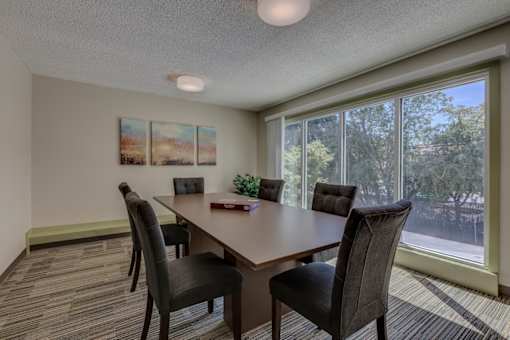 A conference room with a long table and chairs.