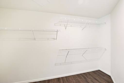 Empty white shelves on the wall.