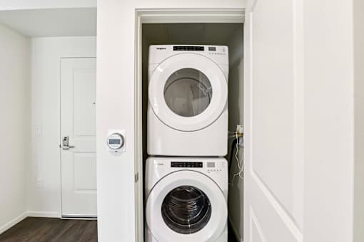 A white washing machine and dryer in a small laundry room.