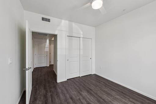A room with a white ceiling and a wooden floor.