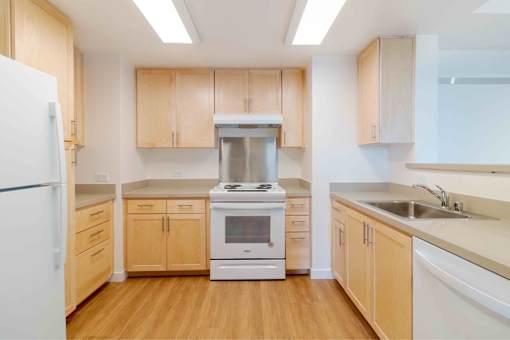 A kitchen with wooden cabinets and a white refrigerator.