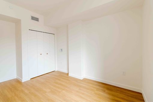 A room with a white door and a white wall.