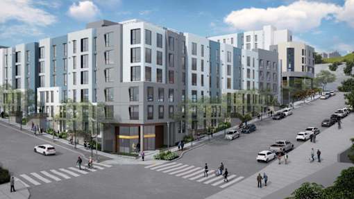 A street view of a residential area with cars and pedestrians.