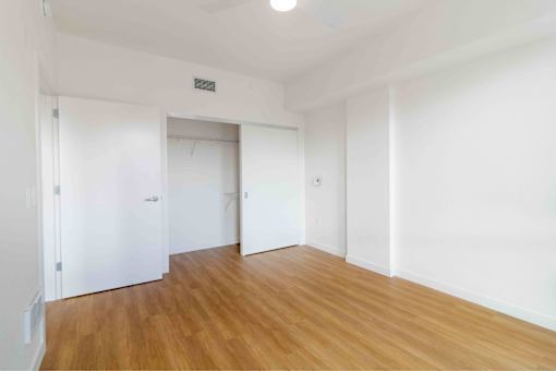 A room with wooden floors and white walls.