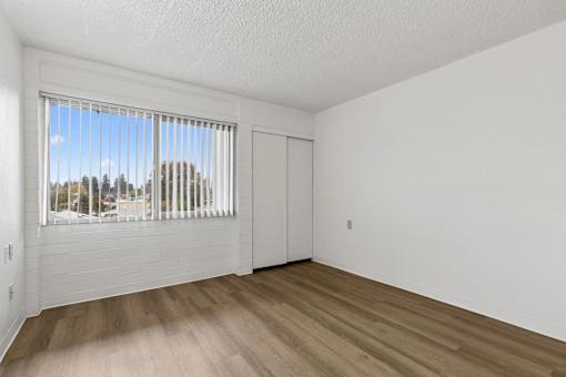 A room with a window overlooking a street.