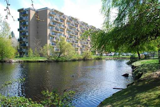 A large building with a lake in front of it.