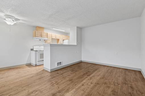 A kitchen area with a microwave, oven, and cabinets.
