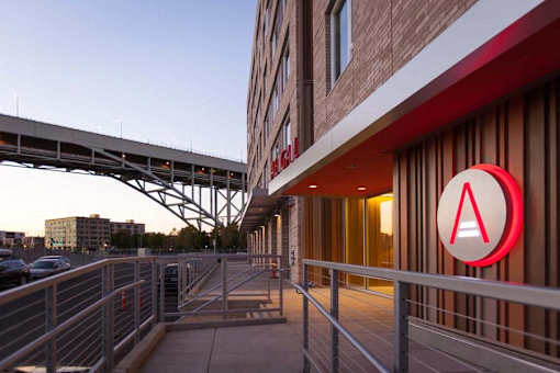 A red and white logo with a white letter A in a circle is on a building.