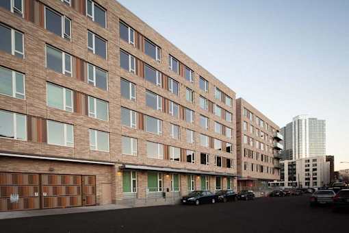 A large building with a parking lot in front of it.