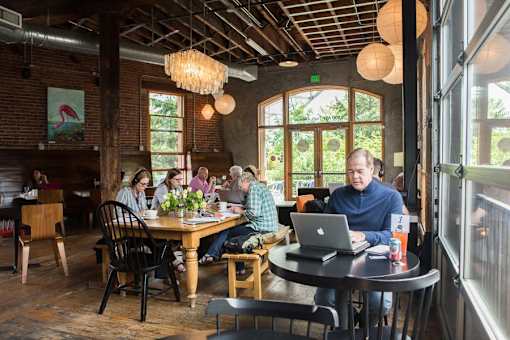 A group of people are sitting around a table in a restaurant.