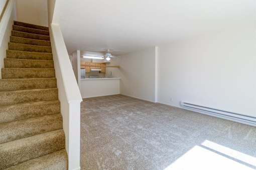 A room with a staircase leading to the upper floor.