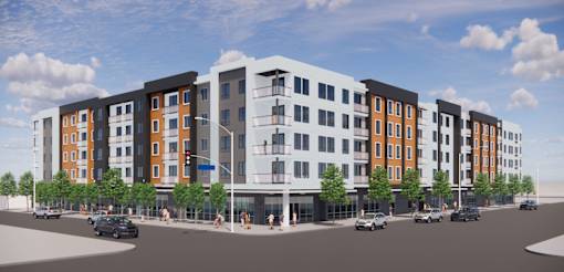 A modern multi-story apartment building with cars parked in front.