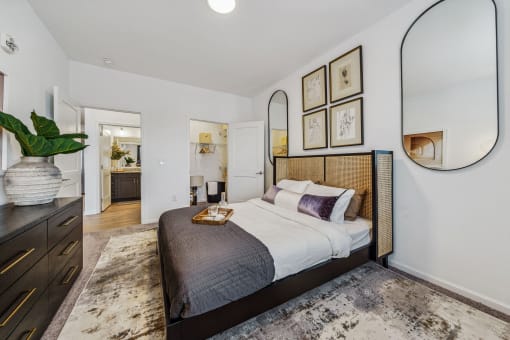 a bedroom with a large bed and a mirror  at Plat 4 at Research Triangle, Durham