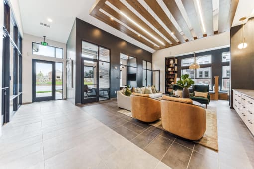 a lobby with couches and chairs and glass doors  at Plat 4 at Research Triangle, Durham, North Carolina