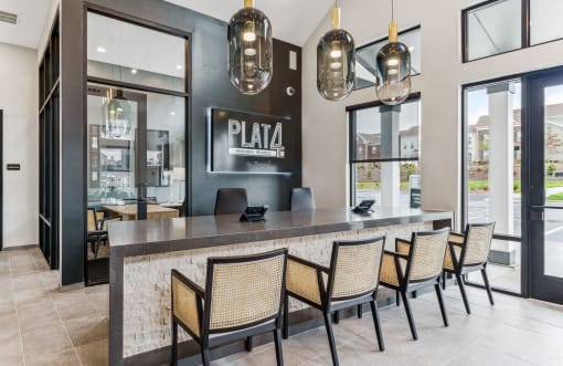 the lobby of a restaurant with a bar and chairs at Plat 4 at Research Triangle, Durham