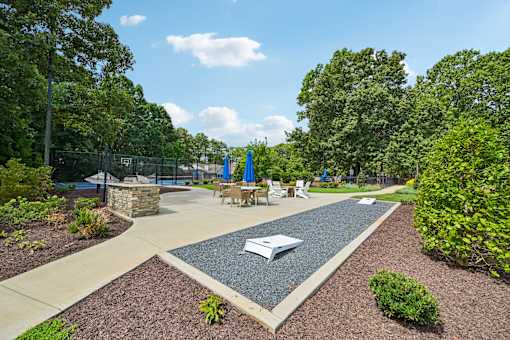 A park with a playground and picnic tables.