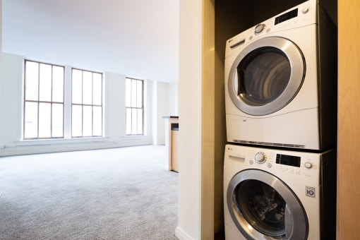 a washer and dryer in a laundry room at 26 West, Managed by Buckingham Urban Living, Indianapolis