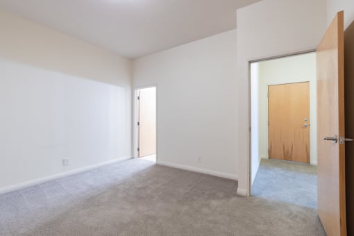 a bedroom with white walls and carpet at 26 West, Managed by Buckingham Urban Living, Indianapolis