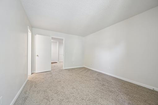 A room with carpeted floor and white walls.