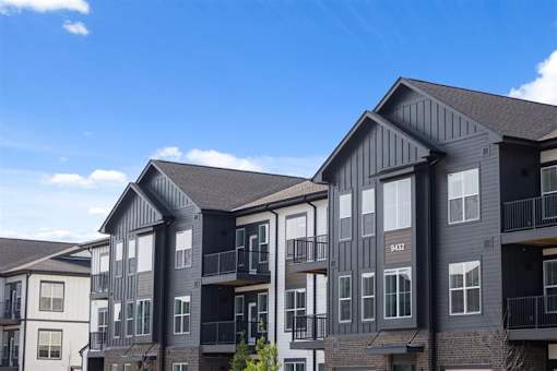 Modern apartment exterior with balconies and black-and-white siding at Nook Nine