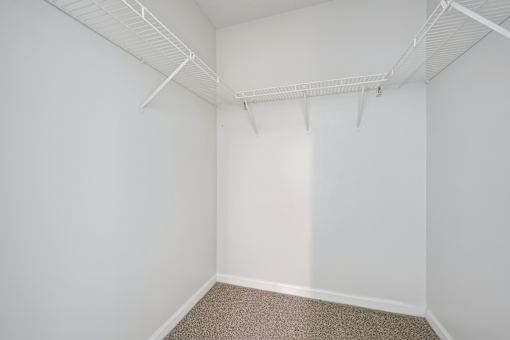 Empty room with white walls and carpeted floor.